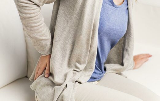 A woman holds her side in pain from a kidney stone