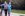 Elderly couple walk along side their bike on a paved biking trail