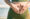 Woman holding a smiley face block in front of her stomach