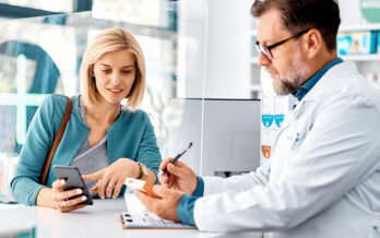 Photo of girl talking to doctor with a prescription