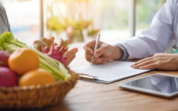 photo of doctor showing results next to fruit
