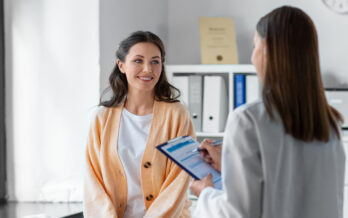Doctor giving results to woman as she is smiling