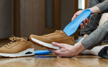 Individual inserts a custom orthotic into their shoe