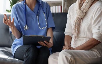 Physician and female patient discuss patient's health