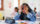 Picture of a girl stressed at school with hands on her head looking down