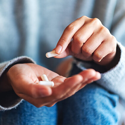 Person holding pills in his hand