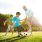 Two young boys play soccer with their dad