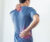 man grabs his lower back and back of neck in pain