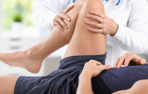 Doctor examining patient's knee