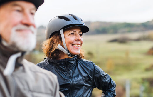 An elderly couple enjoys an active lifestyle by riding bikes