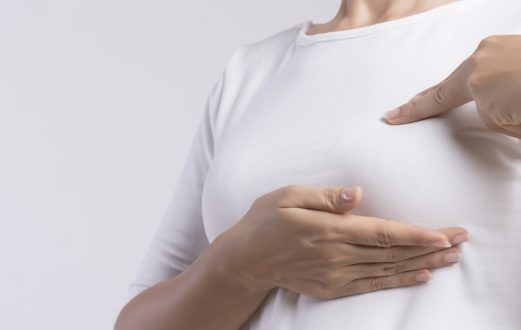 Woman performing a breast cancer self examination