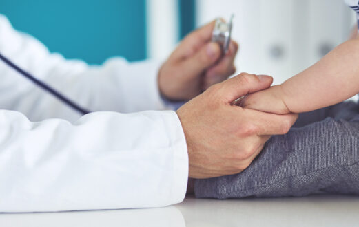 Doctor holding a baby's hand
