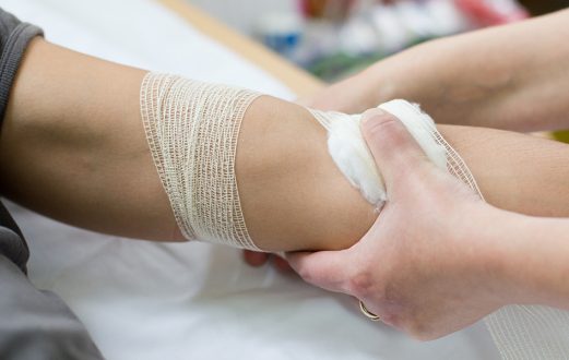 A nurse at Schneck Medical applying a gauze to a patients arm after drawing blood