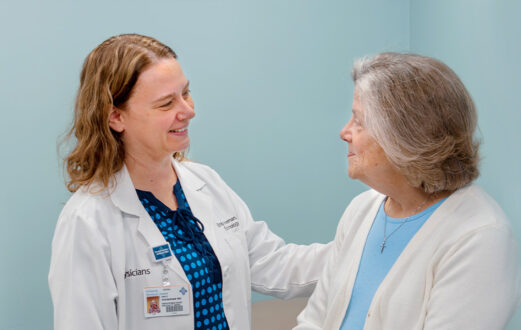 Dr. Veeneman with Schneck Specialty Associates speaks with a patient