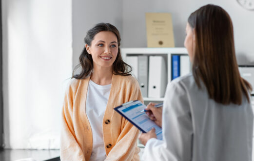 Doctor giving results to woman as she is smiling