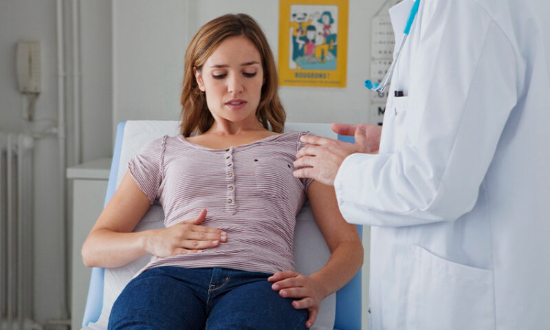 A woman suffering from IBS seeks help from a doctor