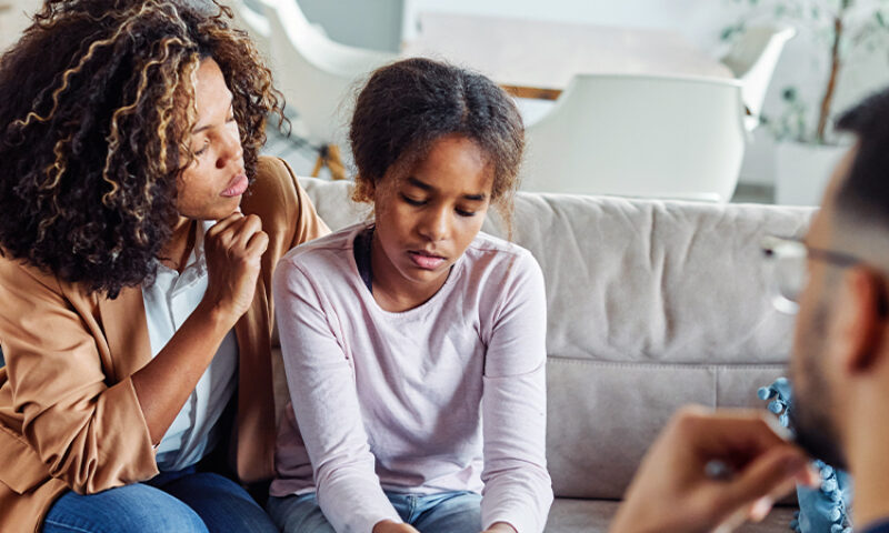 Picture of a mom looking at her child as her child looks sad