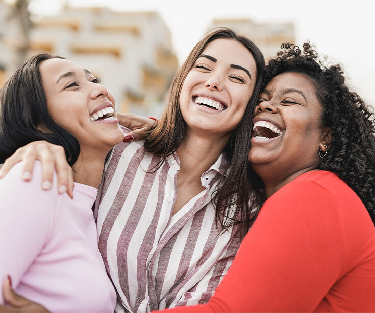 Three women laughing together