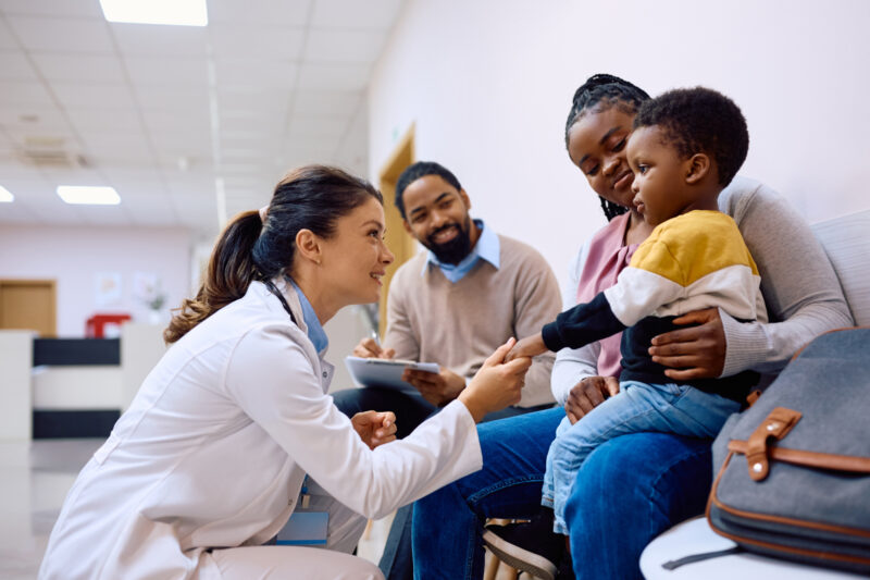 Family at doctor's office meeting with a doctor