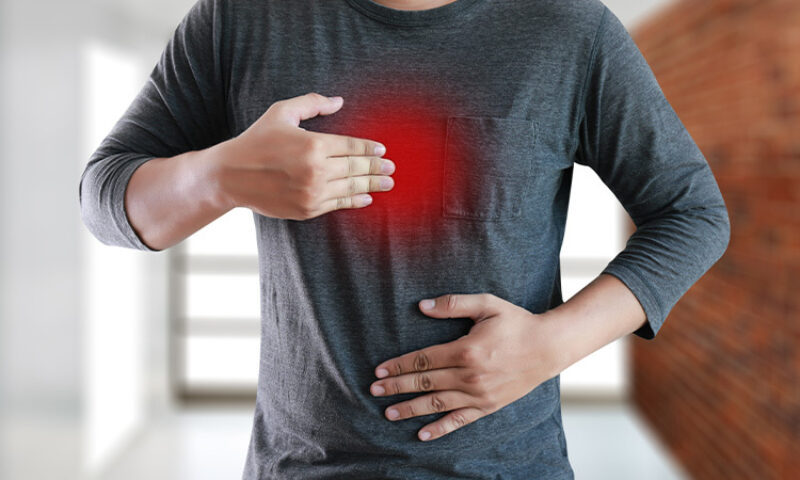 A male figure indicating heartburn pain