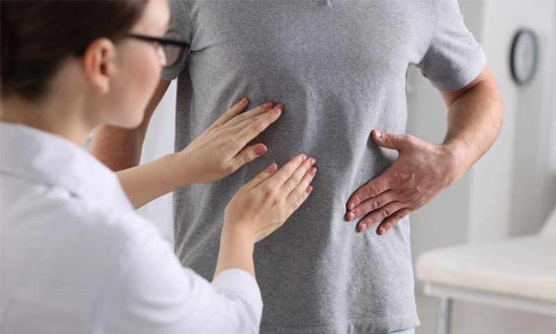 Doctor checking a patient for gallstones pain