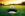 A golfball with the Schneck logo about to drop into the hole