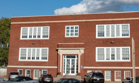 A large brick building stands prominently as the home of the Schneck Medical Foundation.