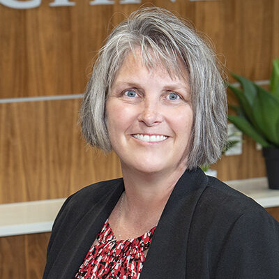 Close up photo of Amy Pettit, Vice President of Patient Care and Chief Nursing Officer.  She is smiling, has gray hair and is wearing a red shirt with black jacket.