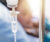 Close up view of IV drip with patient in background