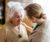 Healthcare worker assisting elderly woman in her home