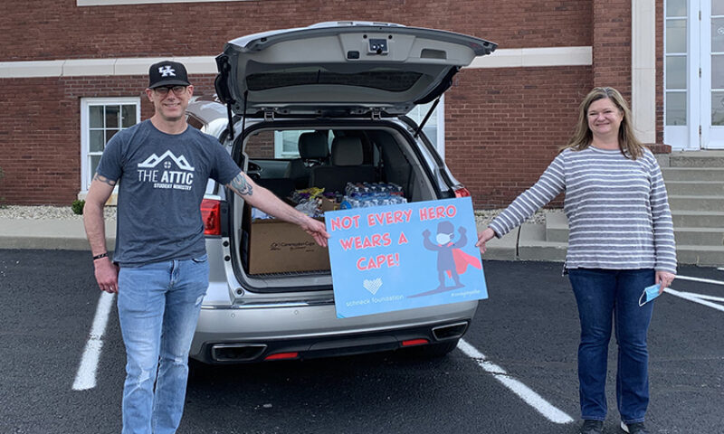 Man and woman holding a banner