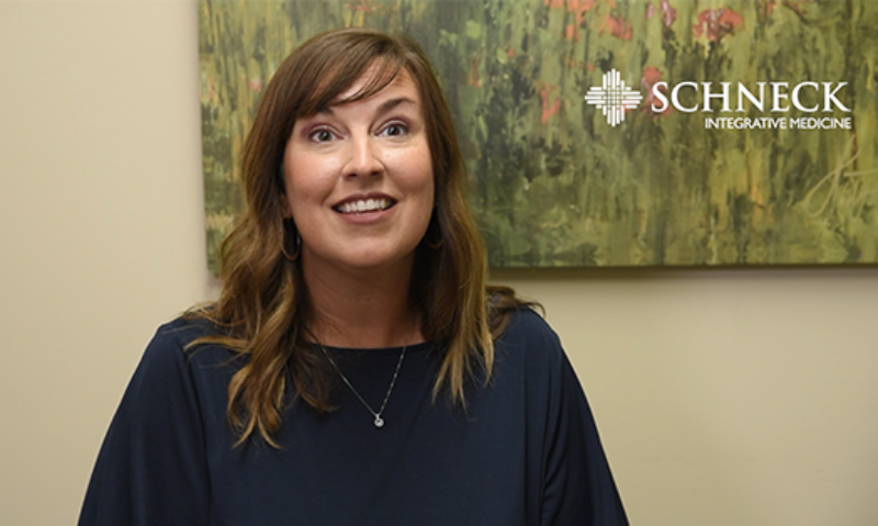Woman sitting in front of painting