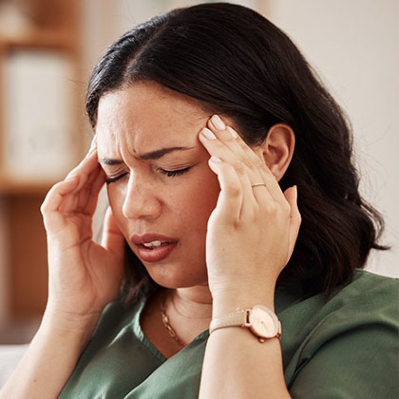 photo of woman rubbing her temples