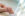 newborn holding mother's thumb