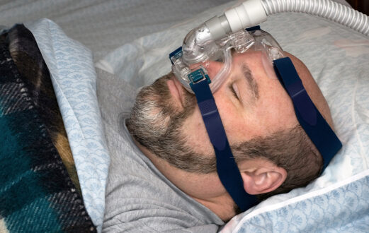 Man using a sleep apnea machine