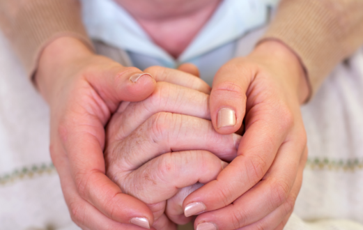 two hands holding another's hand