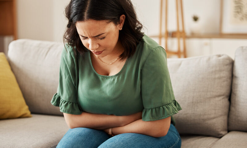 woman sitting hugging her stomach