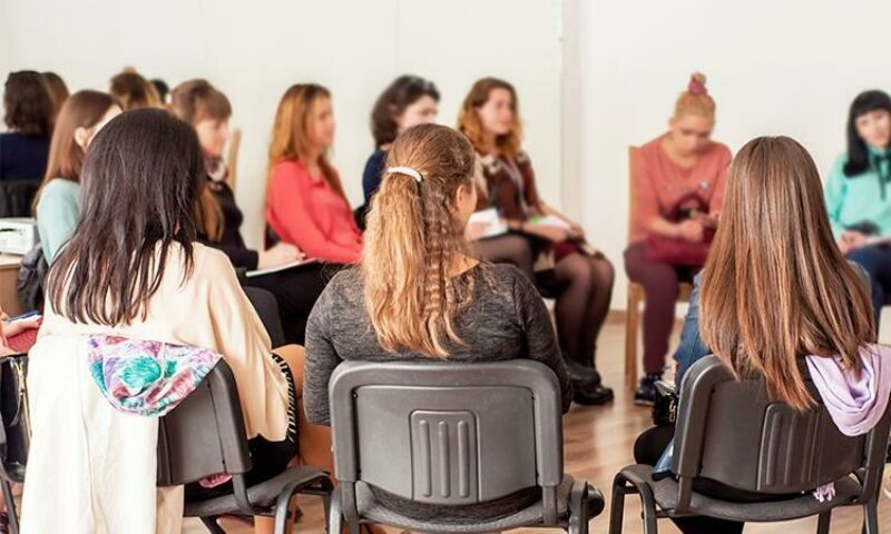 photo of women sitting in a circle