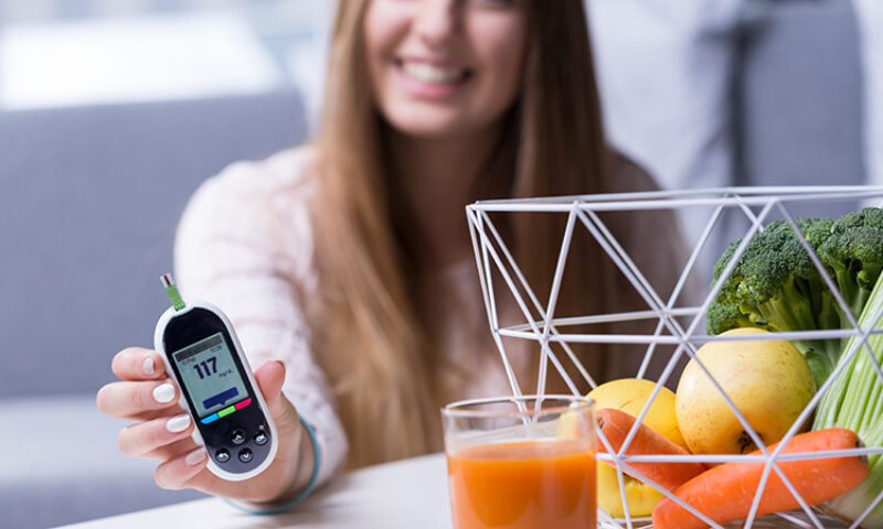 Woman holding a glucometer