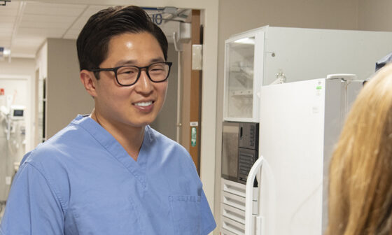 closeup of a doctor smiling at another person