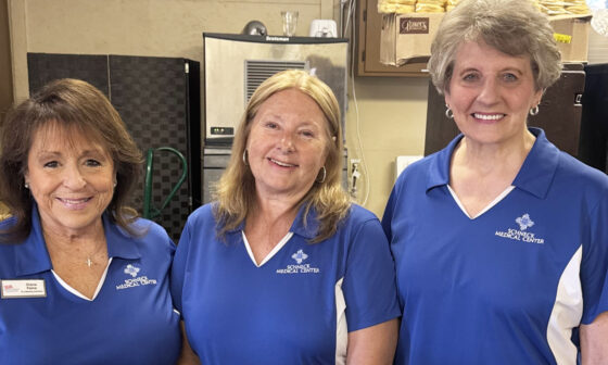 Three Volunteers smiling