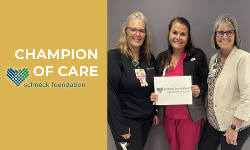 champion of care with women holding an award